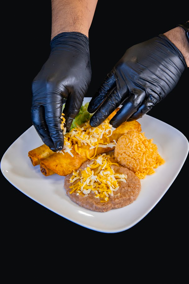 Plating flautas with rice, beans, and cheese