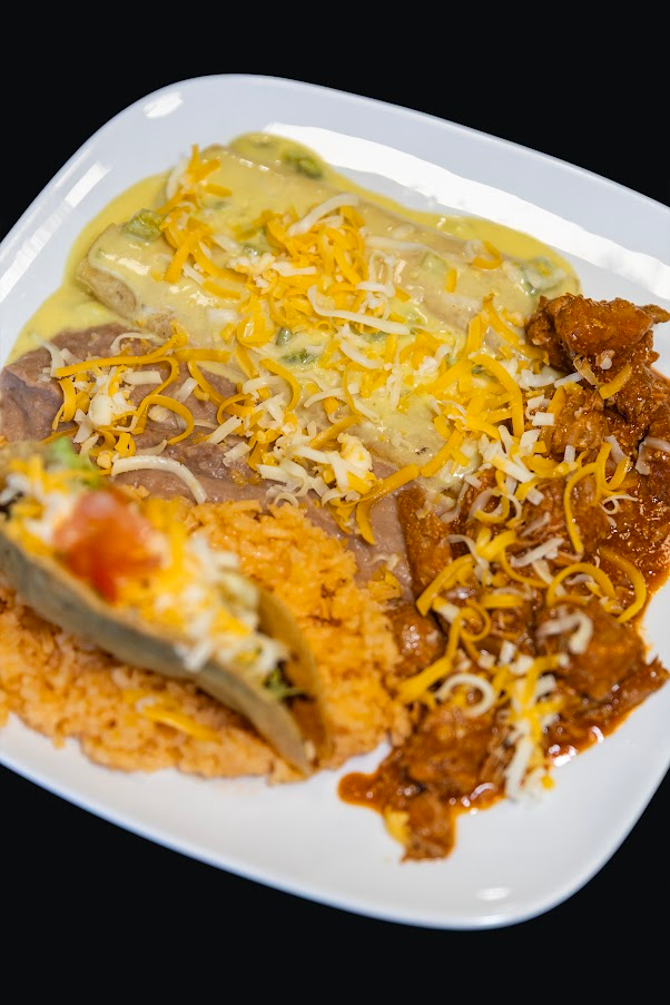 Combination plate with enchiladas, taco, rice and beans